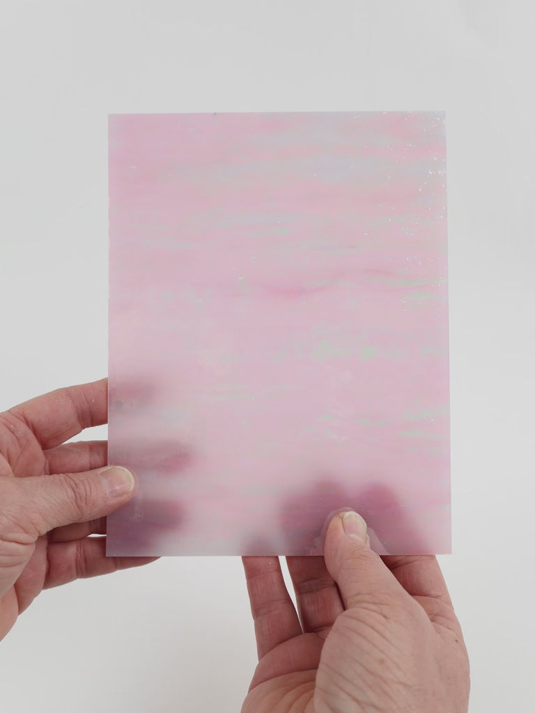Video of the Ballet Pink glass plate in iridescent translucent pink, 15x19cm, held up and tilted to show its pattern and transparency