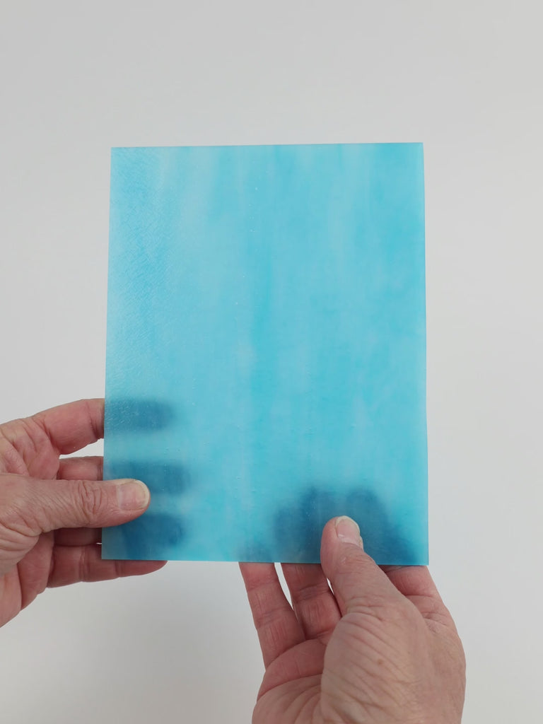 Video of the Azurite glass plate in translucent blue, 15x19cm, held up and tilted to show its pattern and transparency