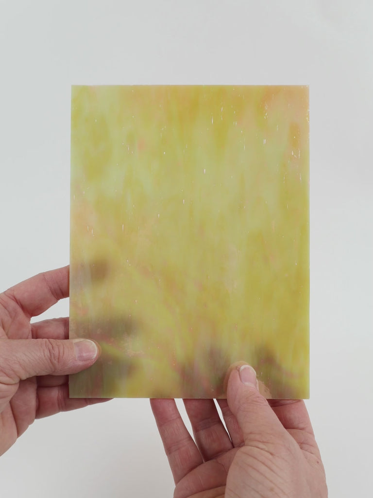 Video of the marzipan glass plate in camel translucent iridescent, 15x19cm, held up and tilted to show its pattern and transparency