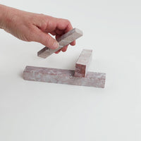 Video of Marble Bars XL Rose in opaque pink natural marble, 1–20 cm long and 8 mm thick, picked up by hand and turned to show their length, colour and natural veining