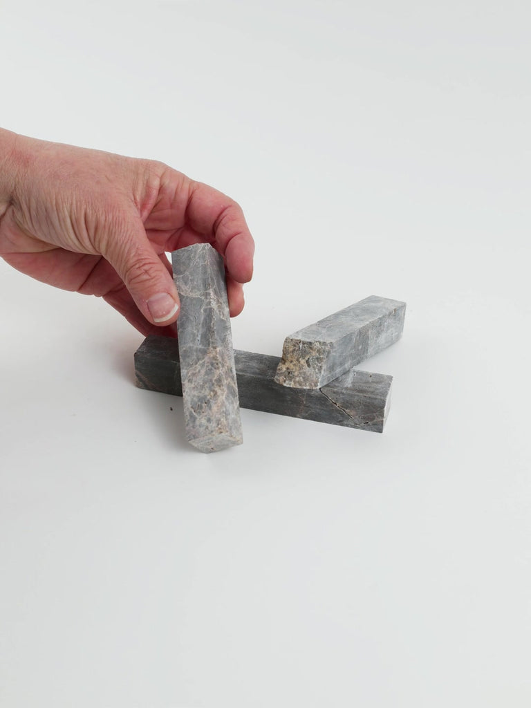 Video of Marble Bars XL Emperador in opaque brown natural marble, 1–20 cm long and 8 mm thick, picked up by hand and turned to show their length, colour and natural veining