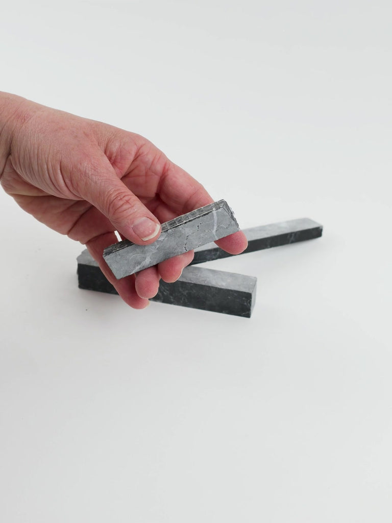 Video of Marble Bars XL Nero Mystic in opaque grey-black natural marble, 1–20 cm long and 8 mm thick, picked up by hand and turned to show their length, colour and natural veining
