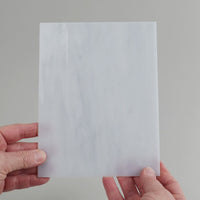 Video of the stone glass plate in grey translucent, 15x19cm, held up and tilted to show its pattern and transparency